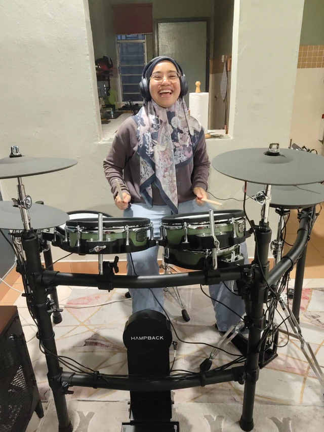 Customer playing a Hampback electronic drum kit at home in Malaysia
