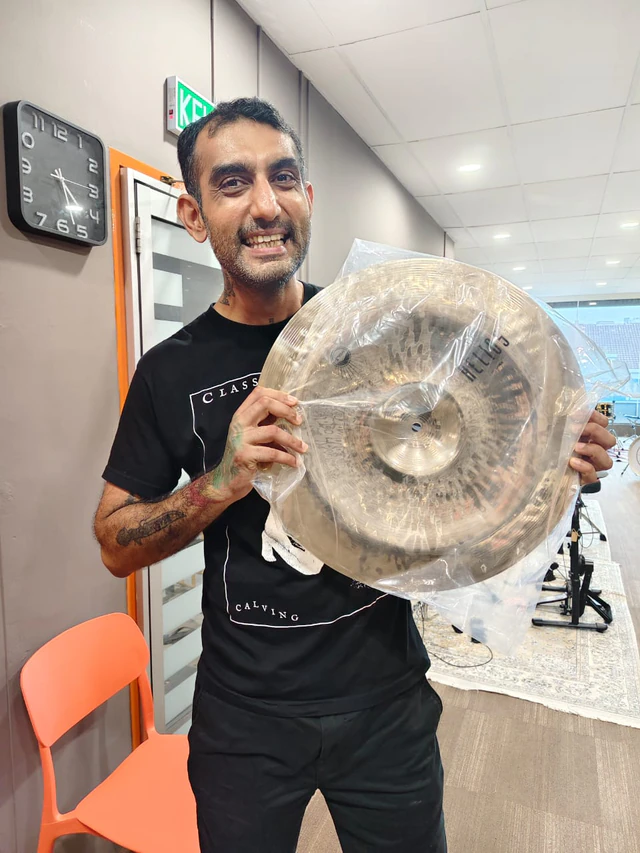 Customer holding a packaged Nimbus Helios cymbal