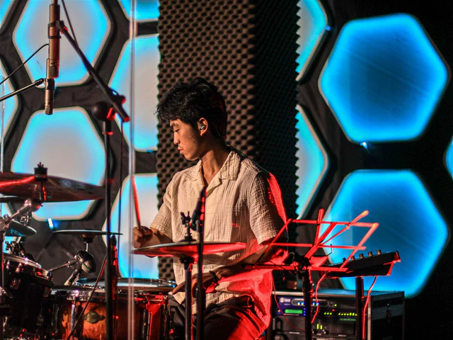 Asian drummer performing live on stage