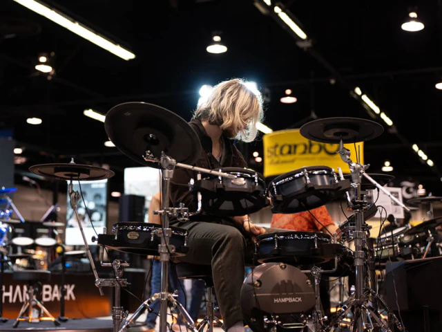 Drummer performing on a Hampback electronic drum kit at NAMM