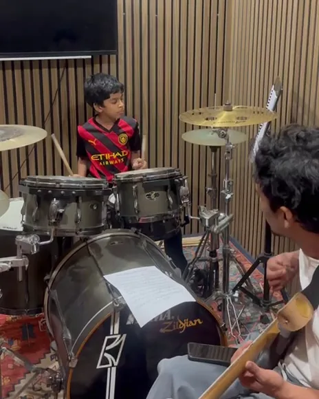 Student practising drums during a practical Soma Music classroom session in Ampang